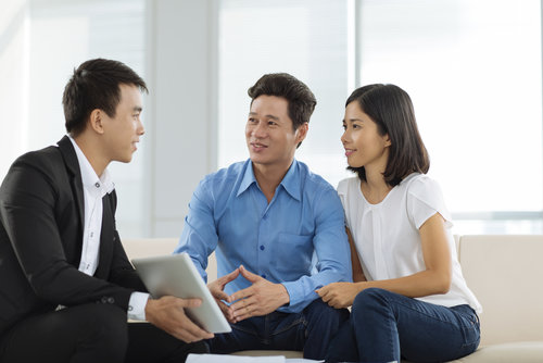 Vietnamese couple talking to advisor in the office